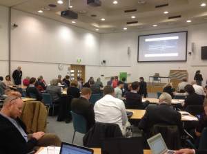 Big Data attendees grouped together having discussions and posting online messages via their wireless devices